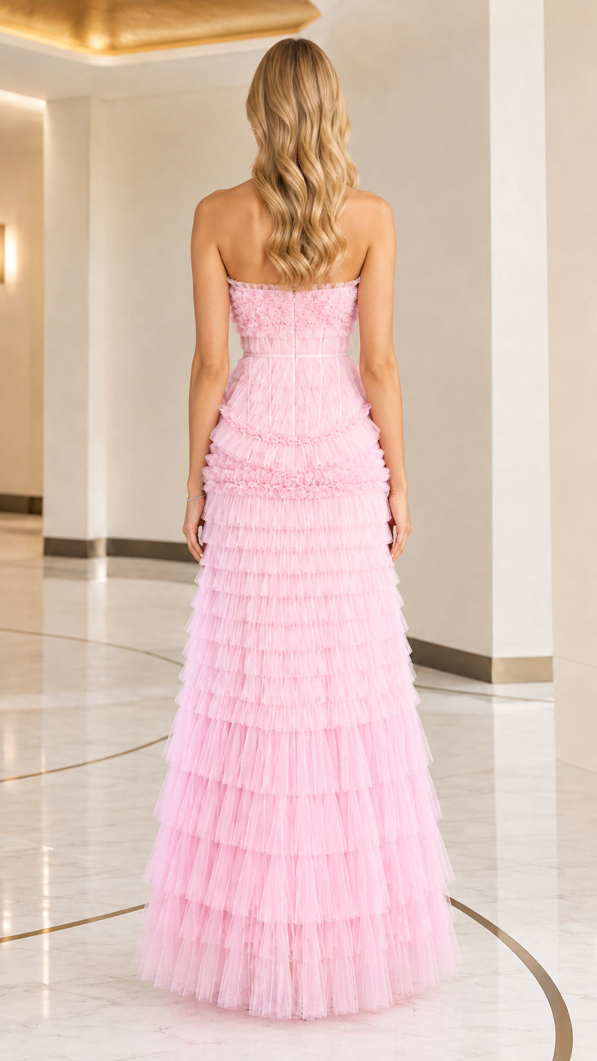 Back view of woman wearing pink tiered ruffle tulle evening dress