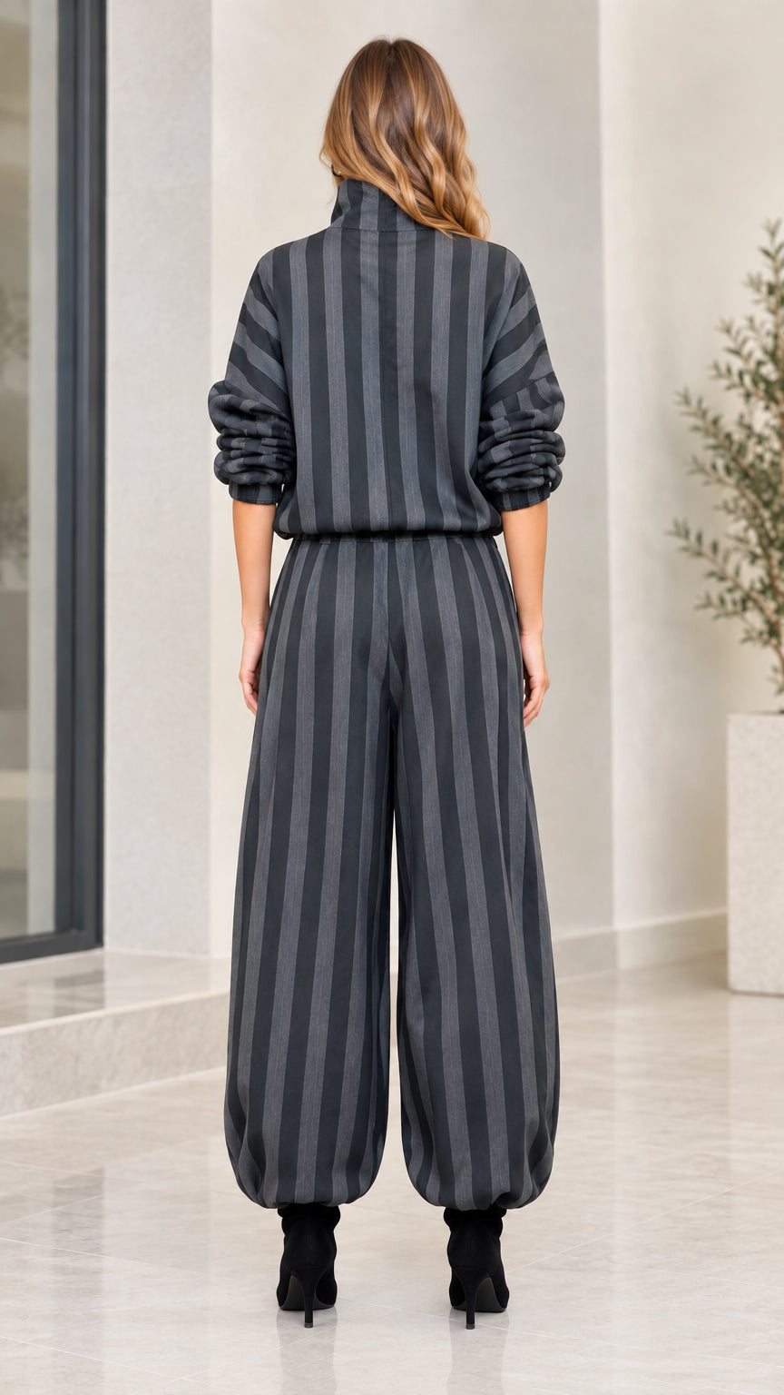 Back view of model showing relaxed fit striped top and balloon pants