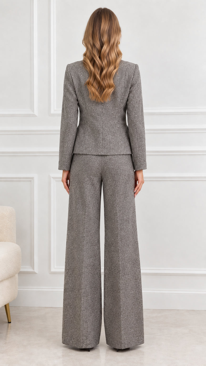 Back view of model wearing Grey tweed tailored jacket and wide leg trousers