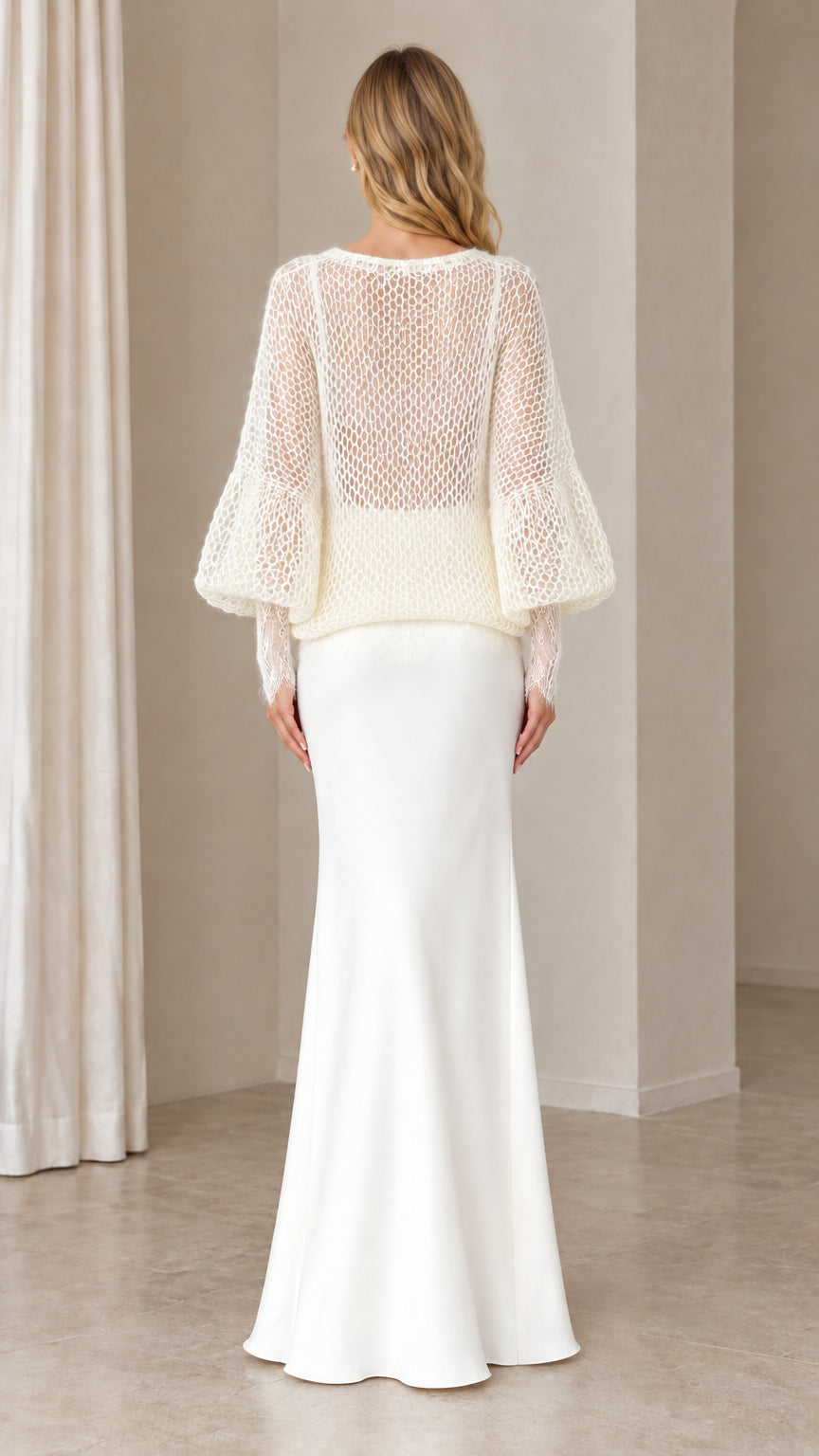 Back view of woman in Ivory open-knit long sleeve cardigan and maxi skirt