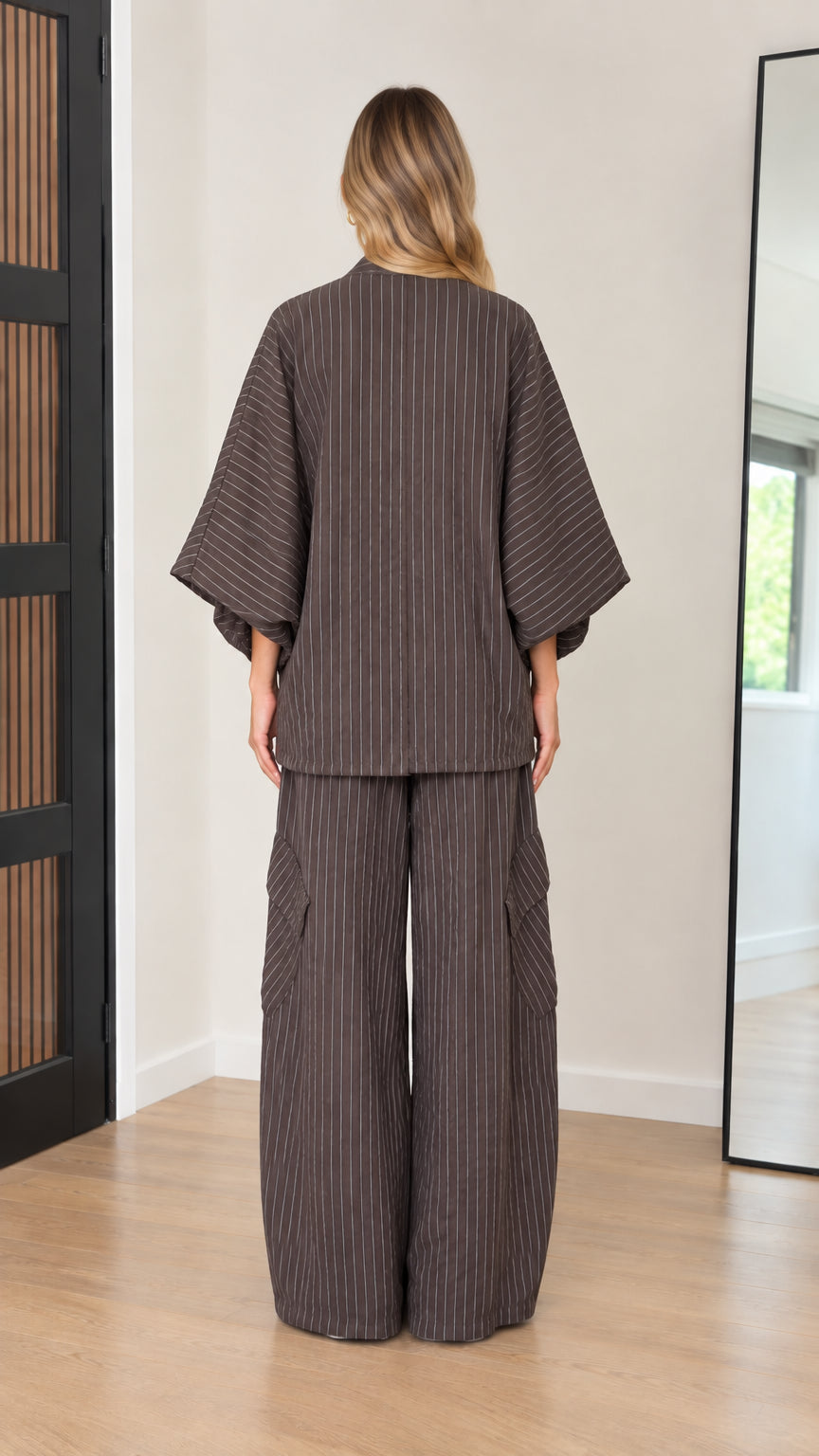 Back view of women's two-piece pinstripe kimono top and wide trousers