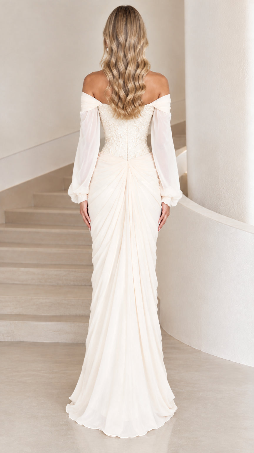 Back view of ivory off-the-shoulder gown showcasing elegant drape and fit
