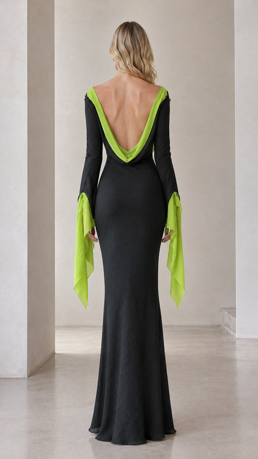 Back view of the black maxi dress showcasing the deep cowl open back