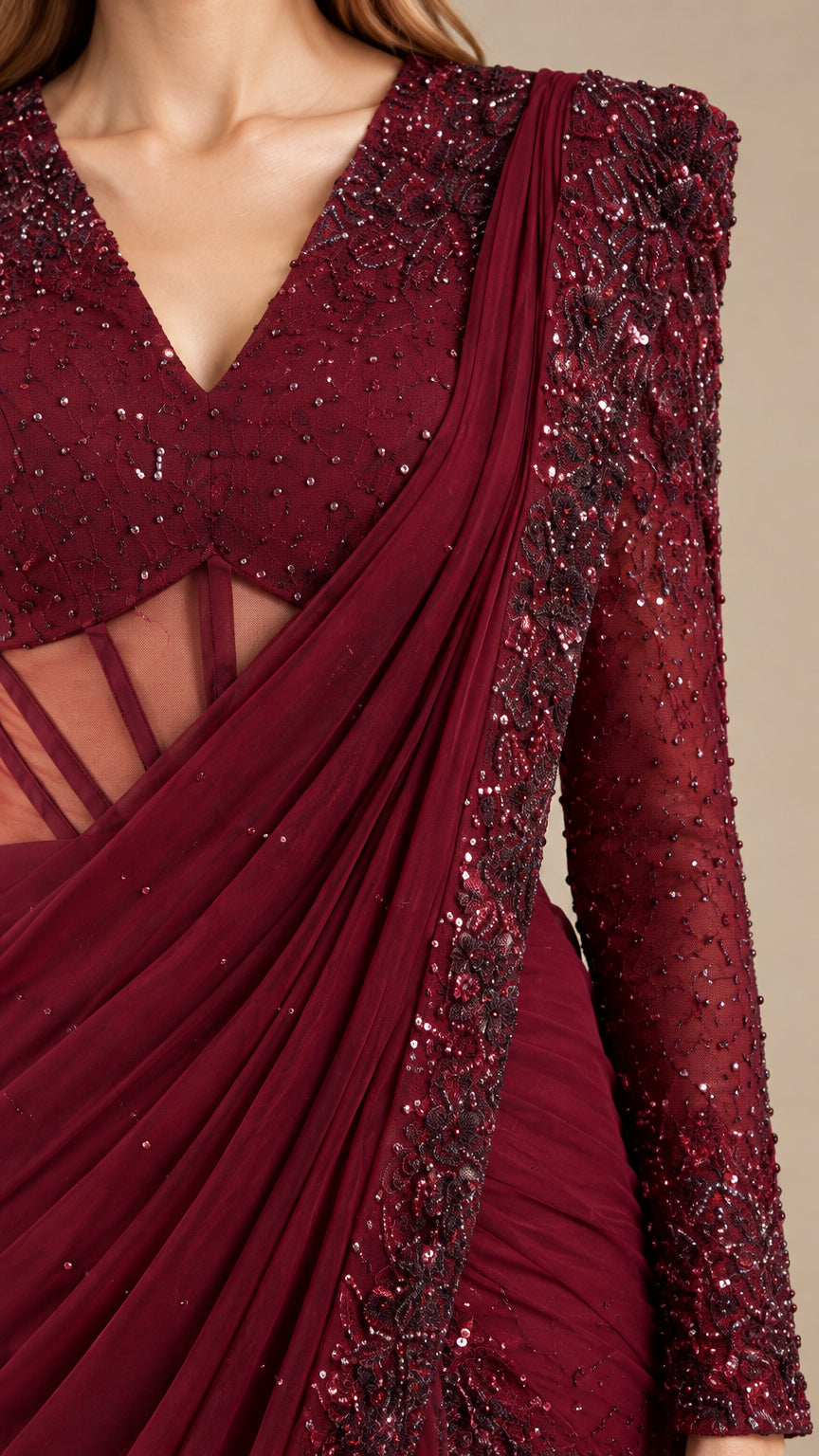 Close-up detail of beaded V-neck bodice, illusion boned waist, and pleated drape in burgundy