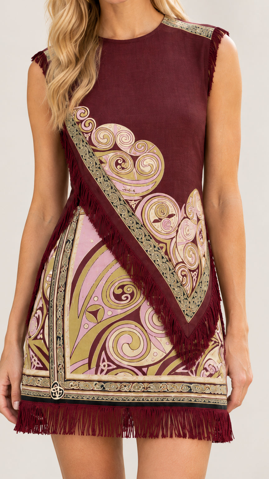 Close-up detail of Burgundy shift dress showing neckline, diagonal fringe, and paisley swirl print