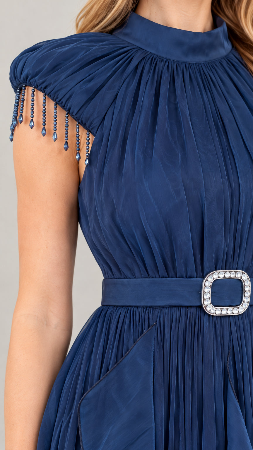 Close-up detail of beaded fringe cap sleeve, high gathered neckline, and rhinestone belt buckle in Navy Blue