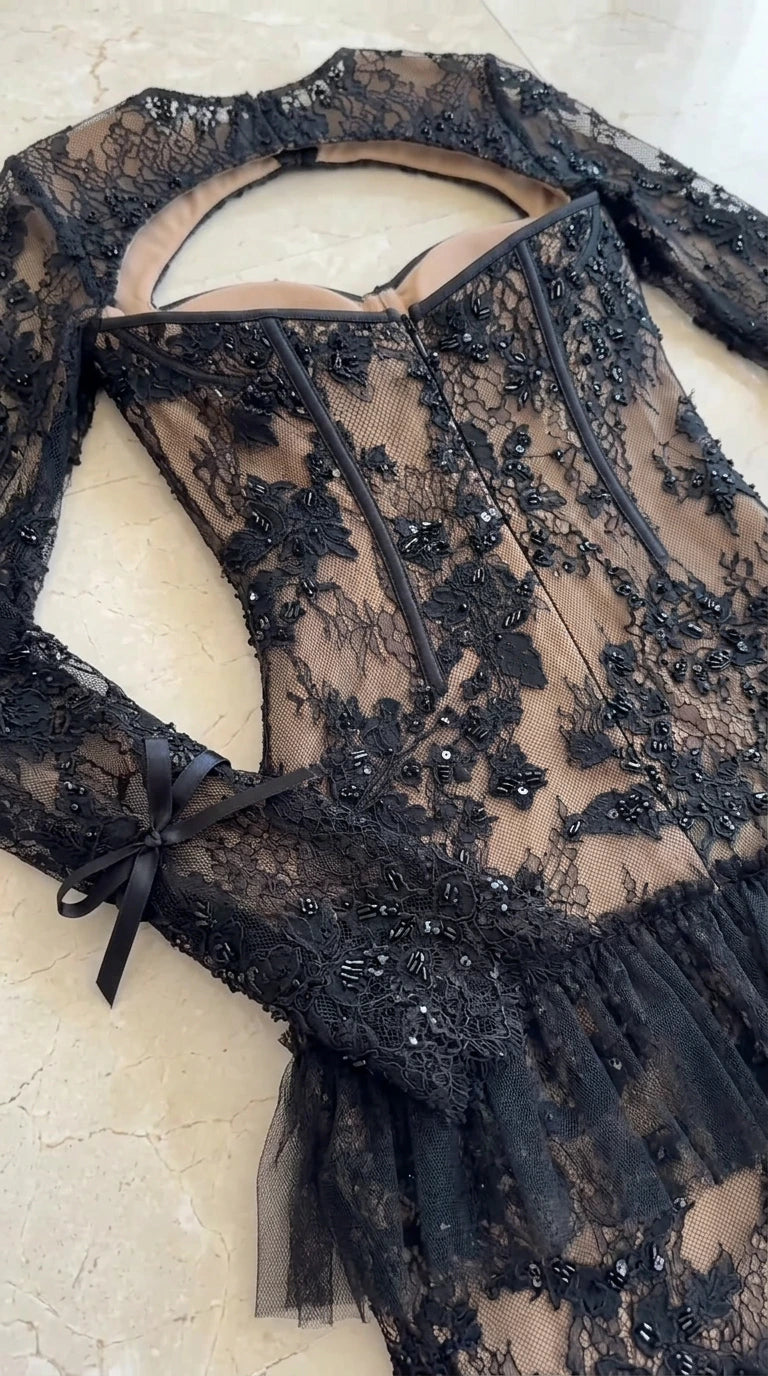 Flat lay close-up of beaded floral lace corset bodice with wrist bow detail