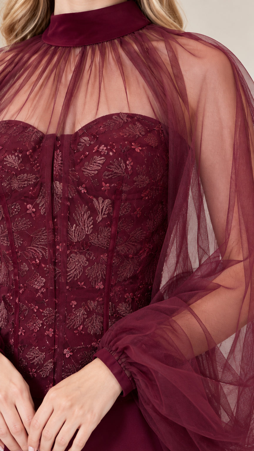 Close-up detail of burgundy embroidered lace corset bodice and gathered tulle neckline