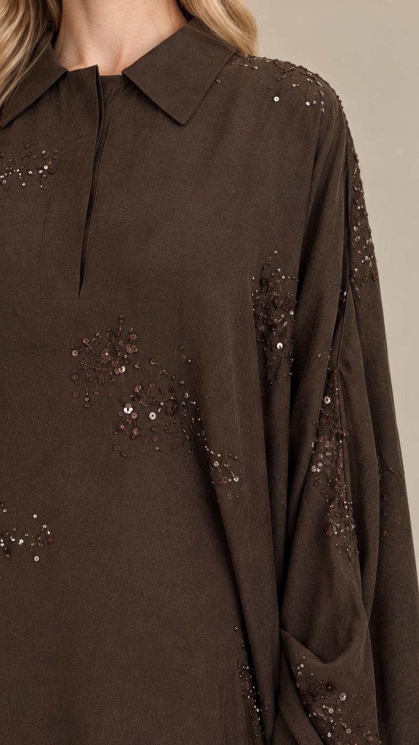 Close-up of Dark Brown kaftan collar, placket, and sequin embellishments
