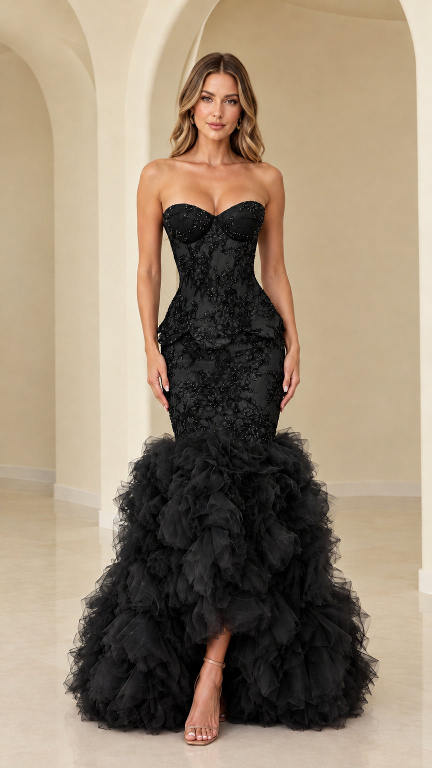 Model wearing black strapless beaded lace corset mermaid gown