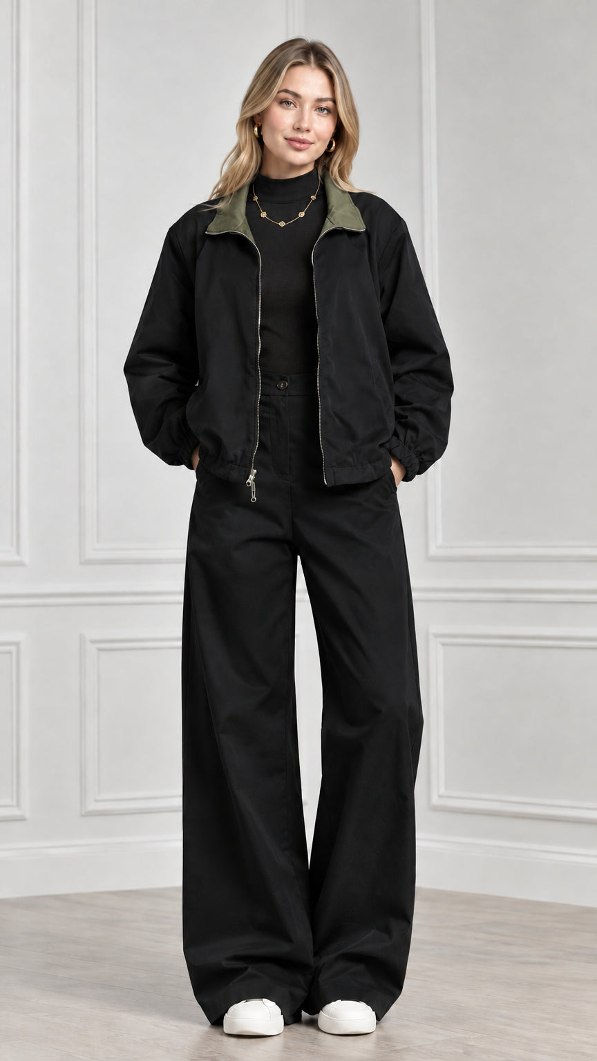 Front view of model wearing black two-piece jacket and wide-leg trouser set