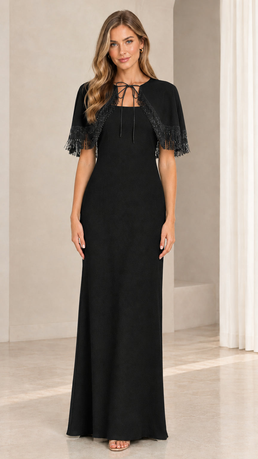 Model wearing black formal maxi dress with beaded fringe capelet