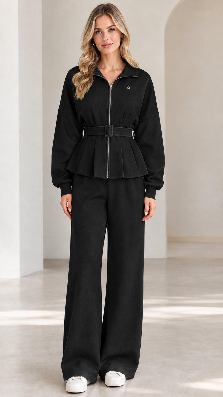 Front full-length view of black zip-up belted peplum jacket and wide-leg pants set