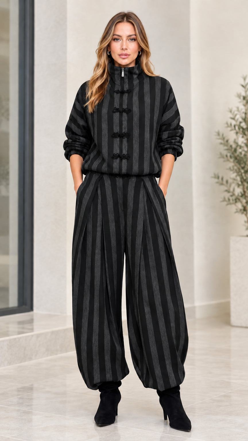 Model wearing black and dark charcoal striped two-piece pant set