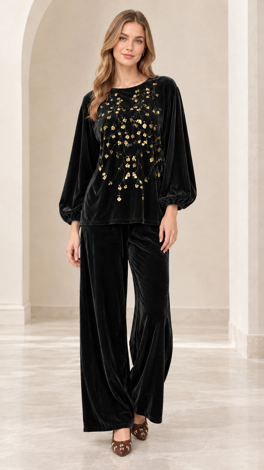 Front view of women's black velvet two-piece set with gold floral sequins