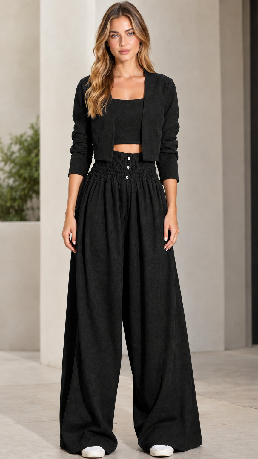 Front view of model wearing black 3-piece crop top, jacket, and wide-leg pants set