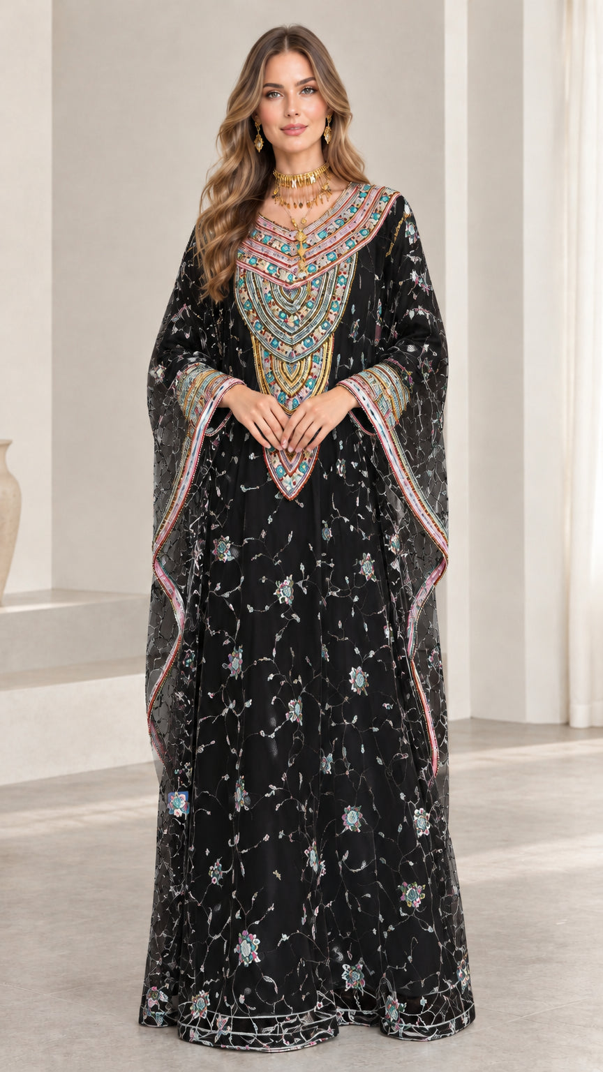 Front full-length view of woman wearing black embroidered kaftan dress with sequins