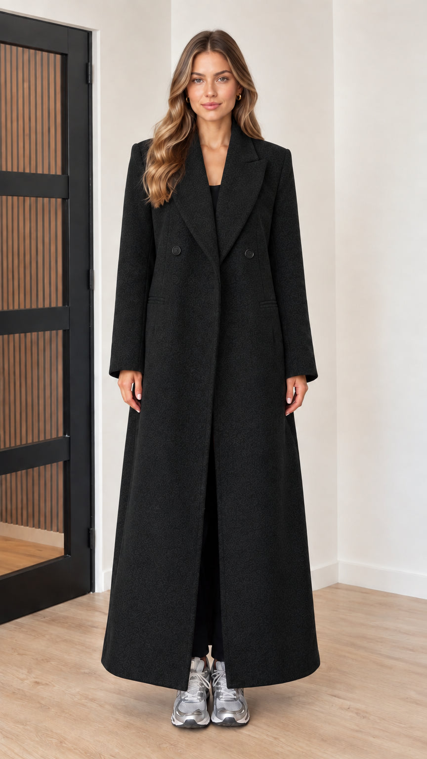 Front view of woman wearing black double-breasted maxi overcoat