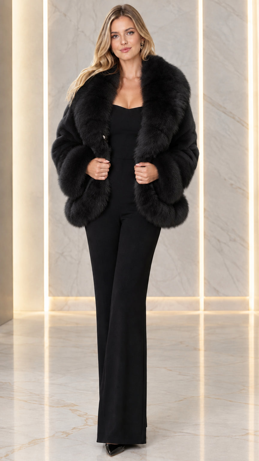 Model wearing black plush faux fur shawl collar jacket over black evening jumpsuit