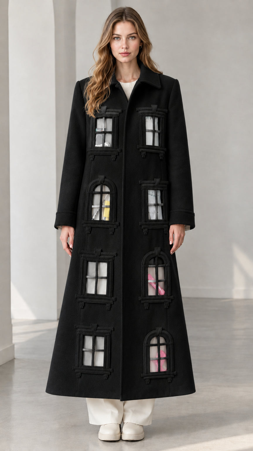 Full-length view of black architectural window appliqué longline overcoat