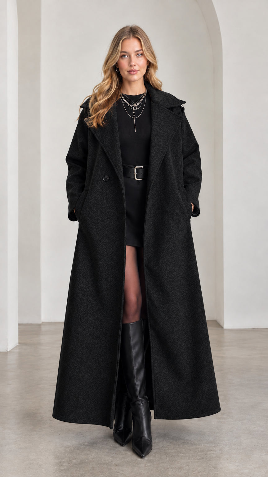 Model wearing classic Black maxi-length tailored overcoat with boots
