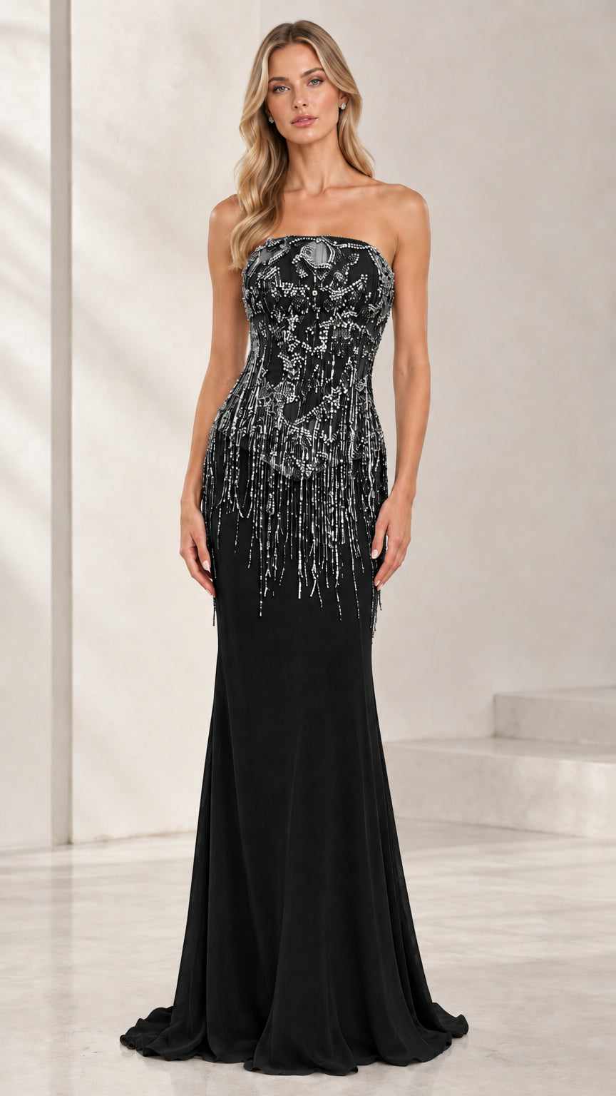 Model wearing black strapless beaded fringe bodice mermaid evening gown