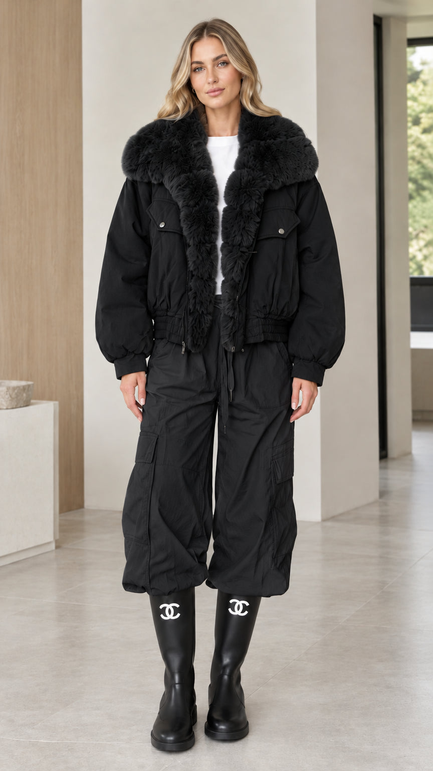 Model wearing black faux fur collar zip-up bomber jacket