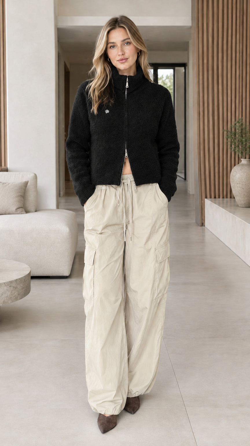 Model wearing black textured fleece stand collar zip-up jacket