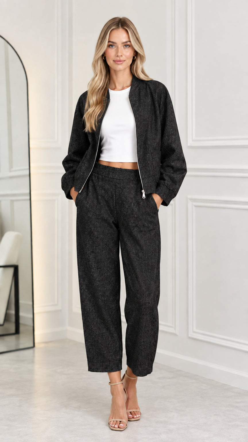 Full front view of model wearing the matching two-piece set in black