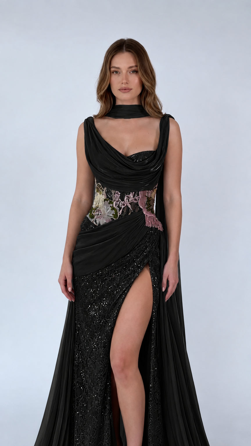 Black cowl neck draped evening gown with sequin lace skirt and shoulder cape