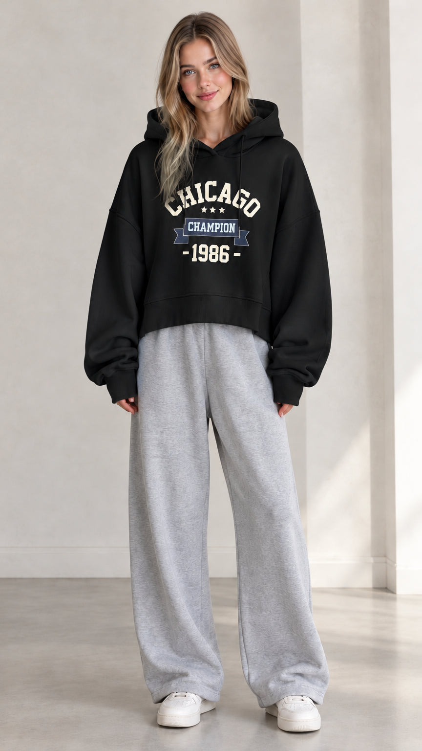 Front view of woman wearing Black Chicago graphic cropped hoodie