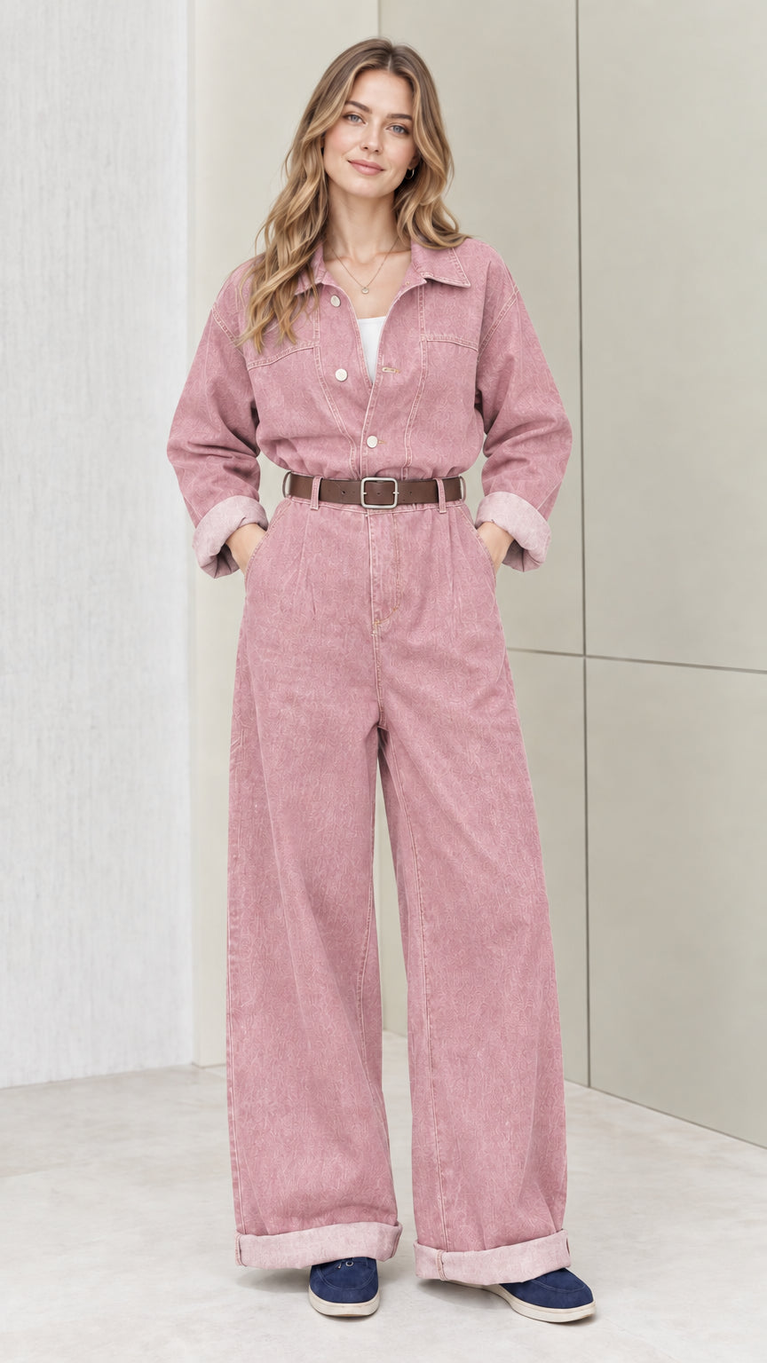 Front view of woman wearing dusty pink wide-leg denim jumpsuit with belt
