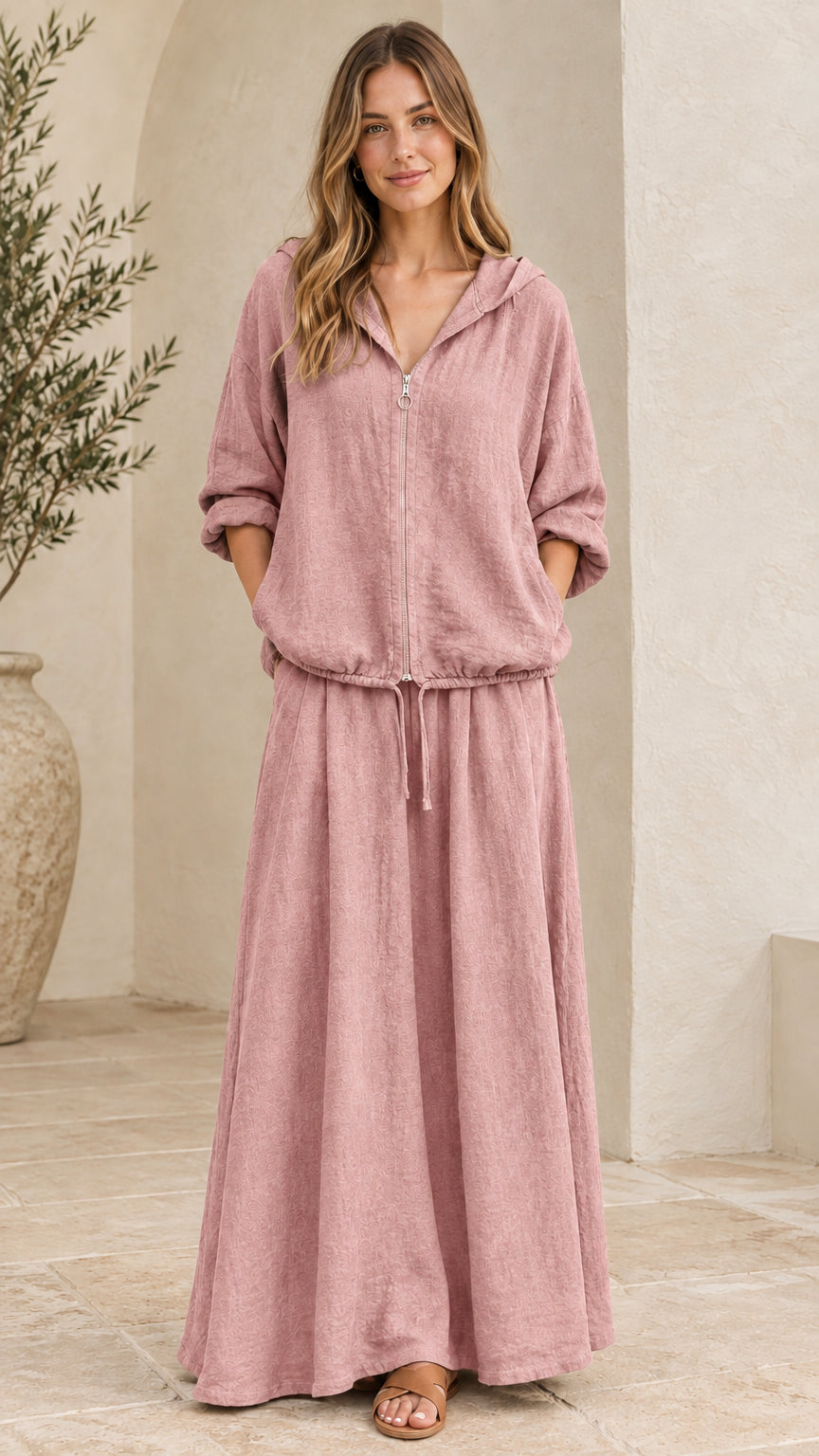 Front view of woman wearing dusty pink hooded top and matching maxi skirt set