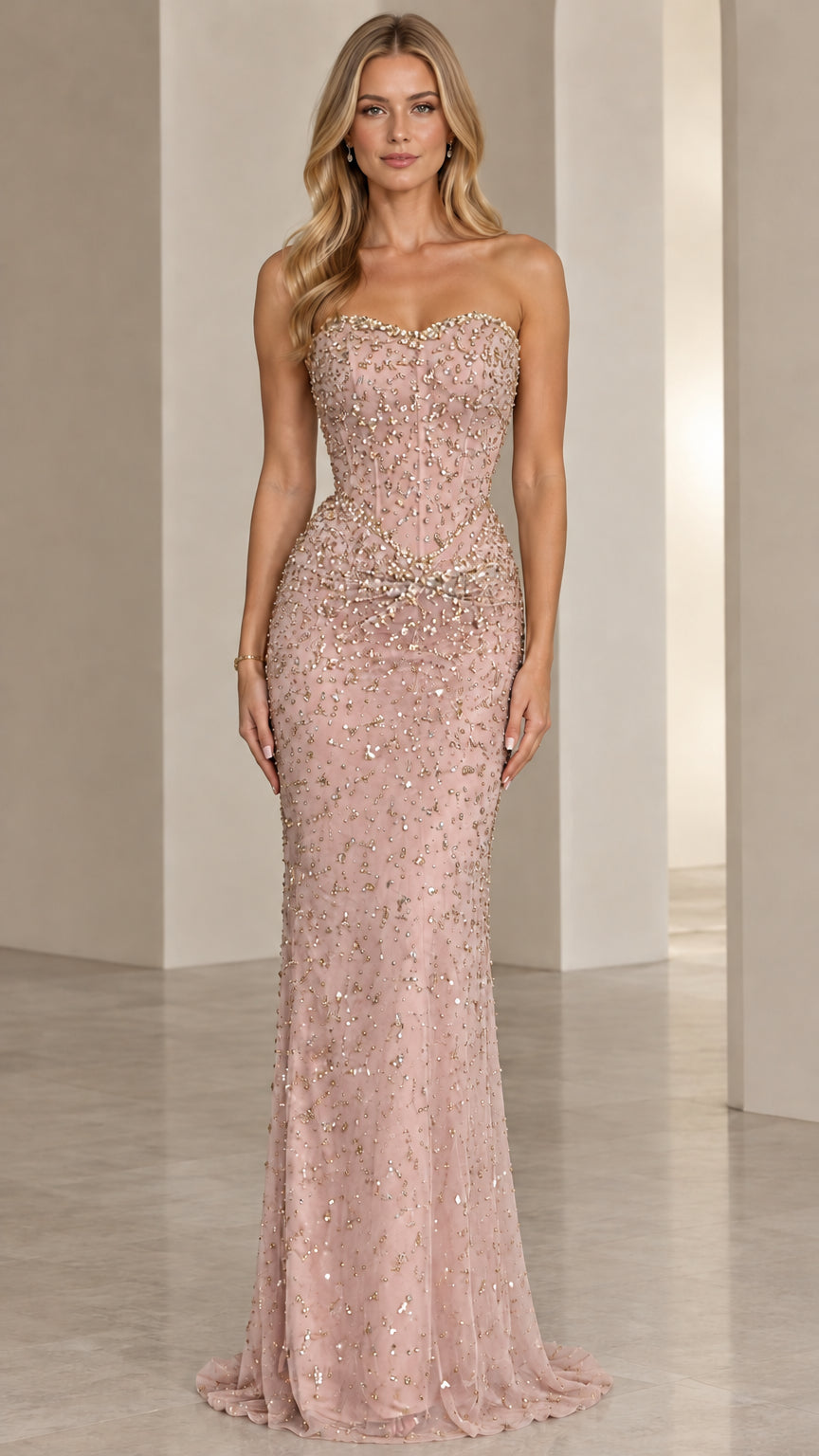 Front view of model wearing Blush Pink strapless beaded corset evening gown