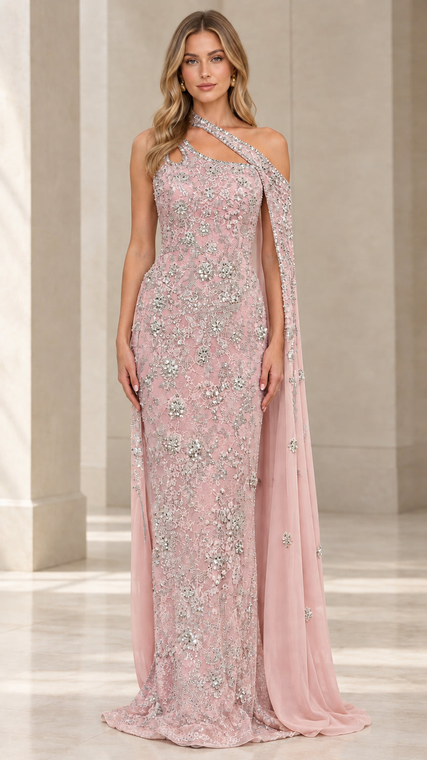 Front view of blush pink embellished one-shoulder formal dress with flowing cape