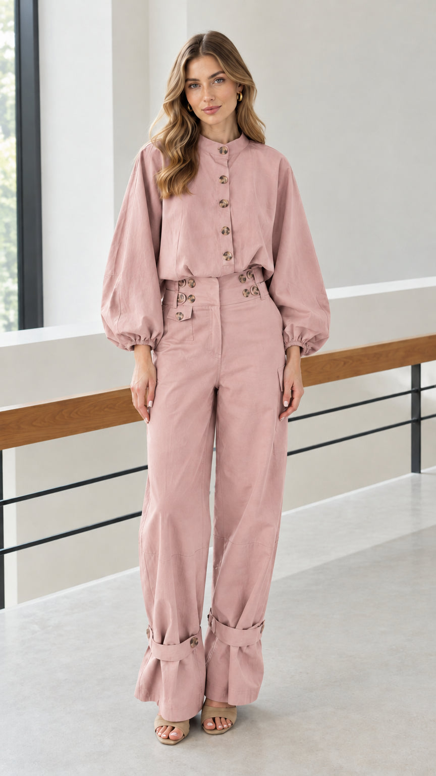 Front view of woman wearing dusty pink matching utility pant set
