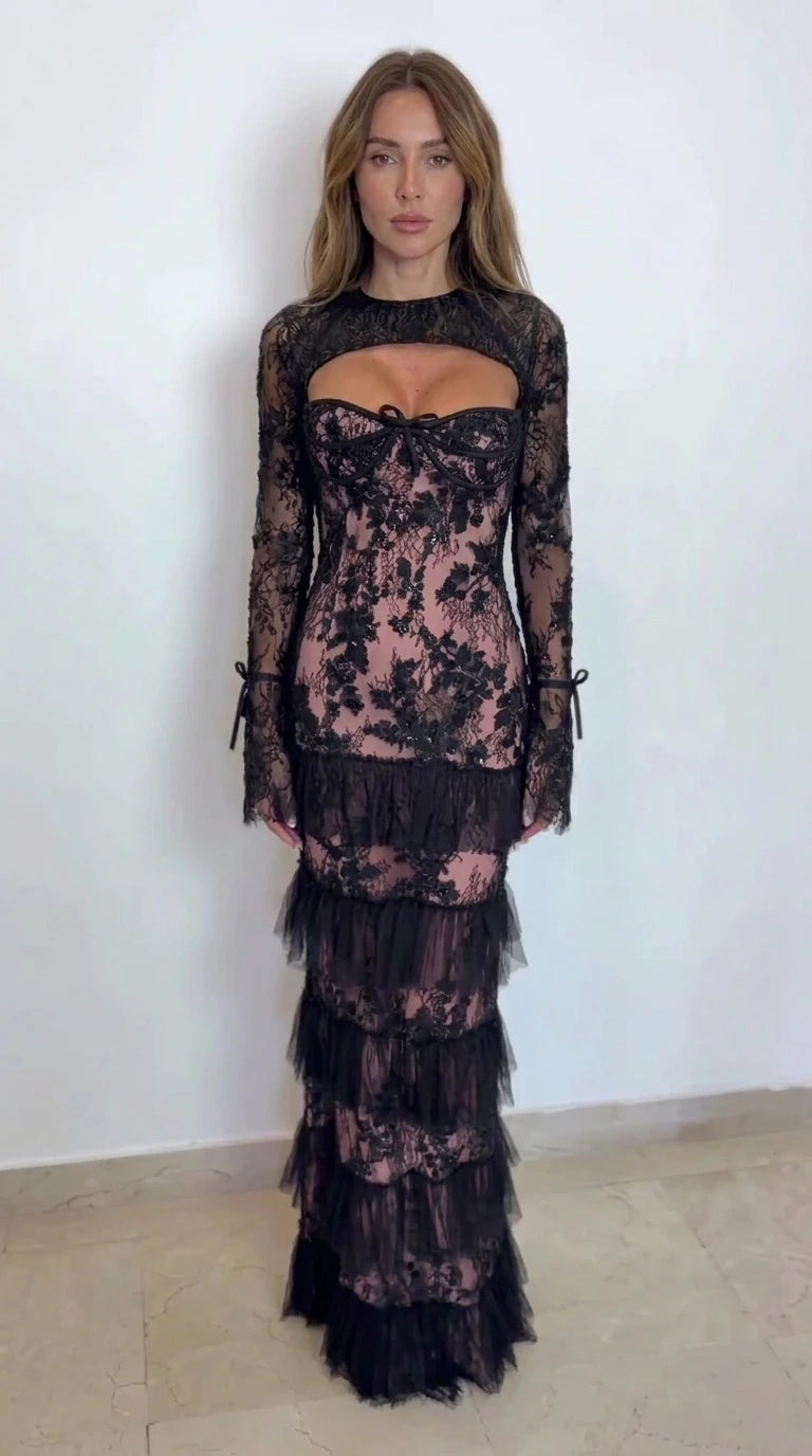 Model wearing black lace tiered maxi dress with dusty rose pink lining