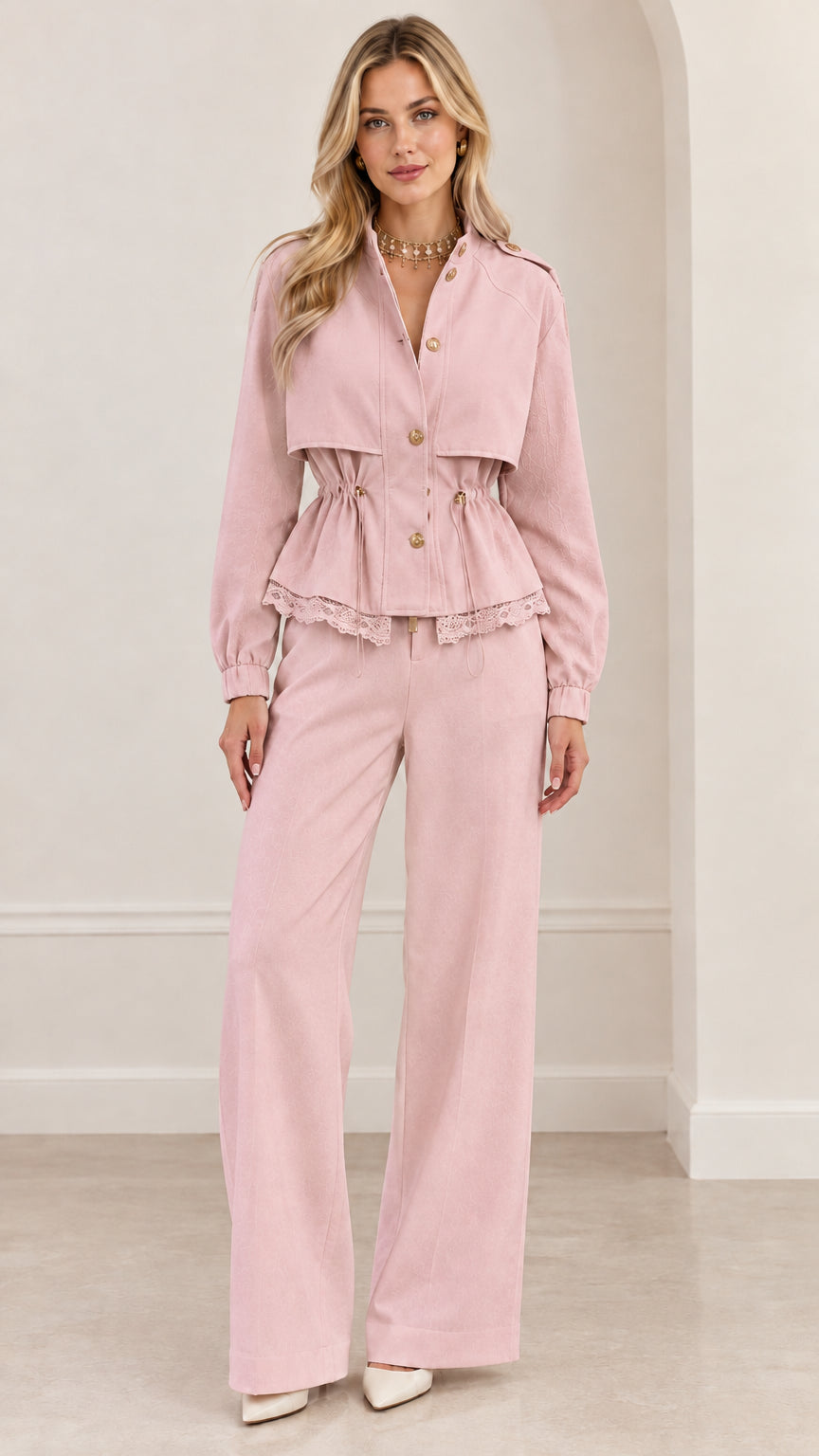 Full-length view of woman wearing dusty pink peplum jacket and matching wide-leg trousers