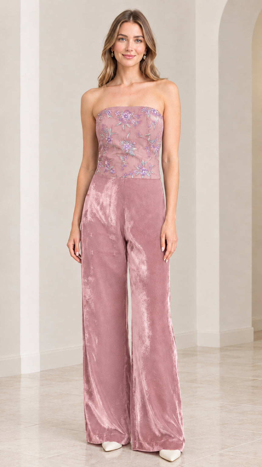 Front view of woman wearing strapless dusty rose pink velvet wide leg jumpsuit