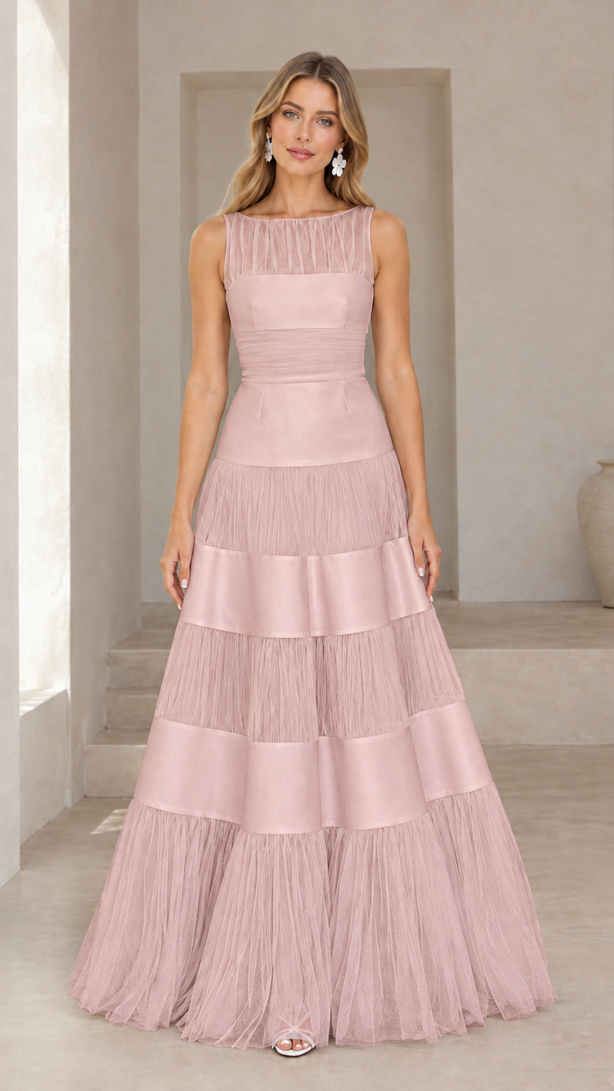 Front view of model wearing blush pink tiered tulle and satin evening gown