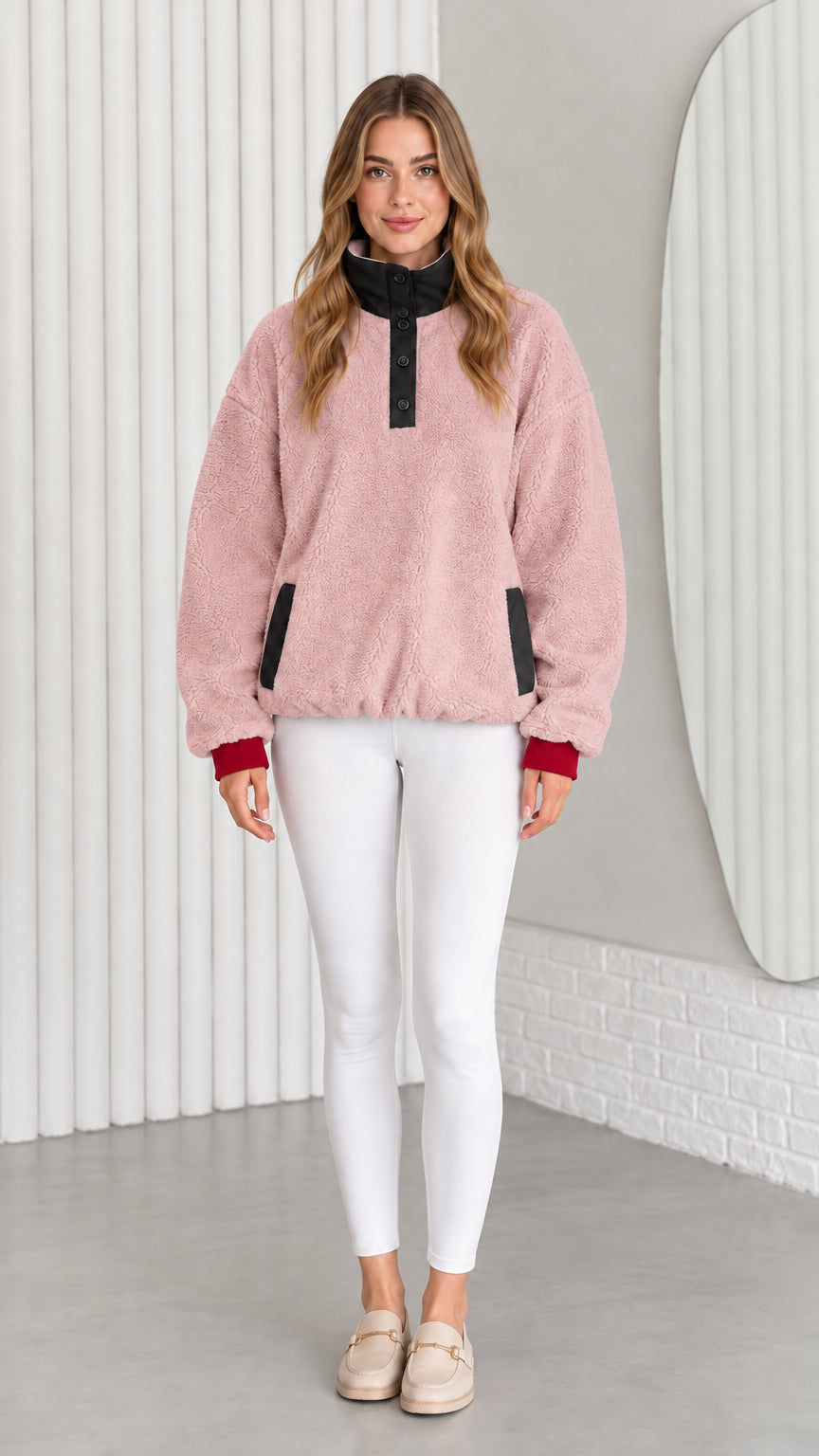 Model wearing dusty pink sherpa fleece pullover sweatshirt with black collar trim