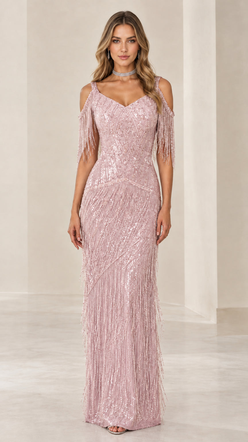 Front view of woman wearing Blush Pink sequin cold-shoulder fringe maxi evening gown