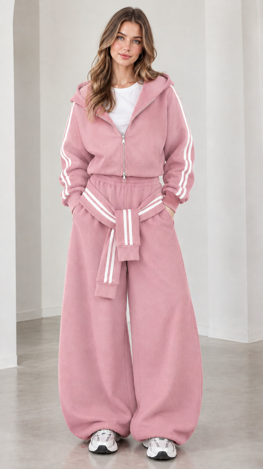 Model wearing dusty pink cropped zip hoodie and wide-leg sweatpants set