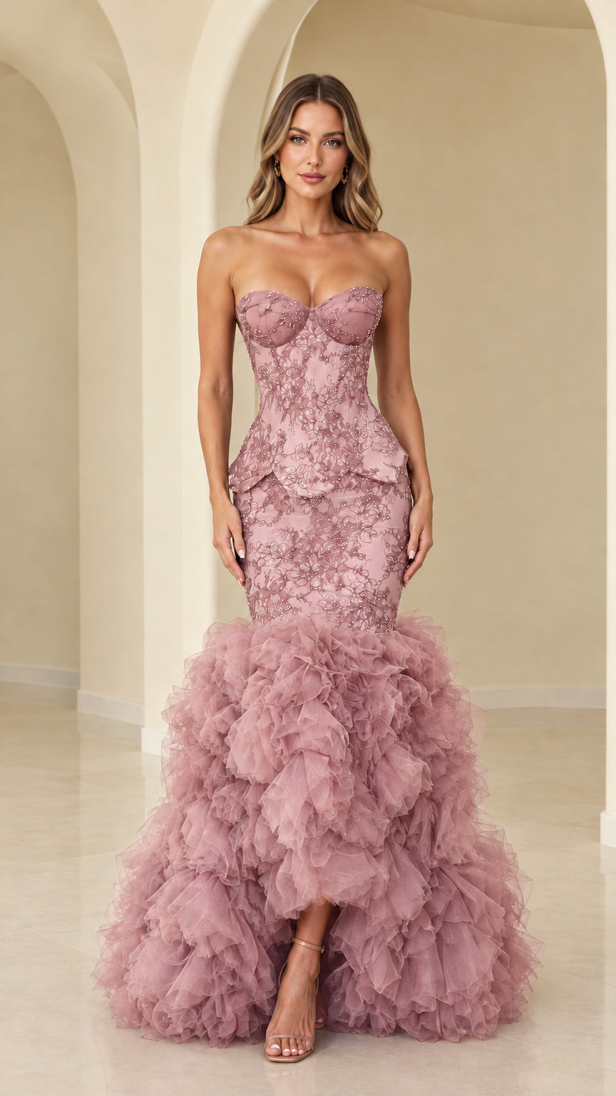 Model wearing dusty rose strapless beaded lace mermaid evening gown