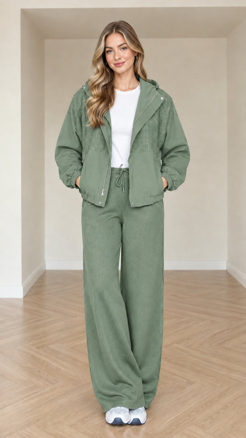Model wearing sage green women's zip-front hooded jacket and pant set