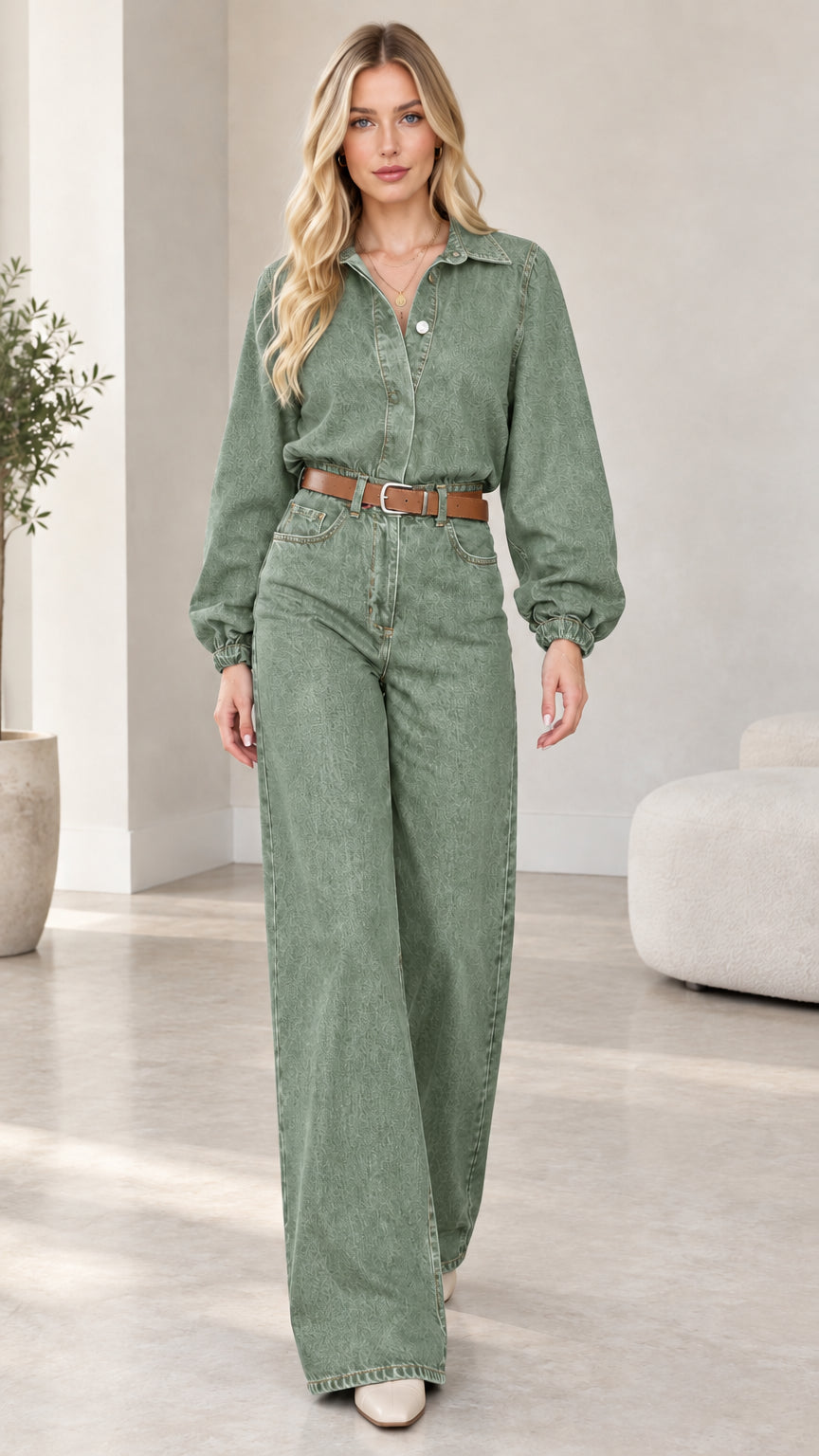 Model wearing sage green wide-leg denim jumpsuit with brown belt