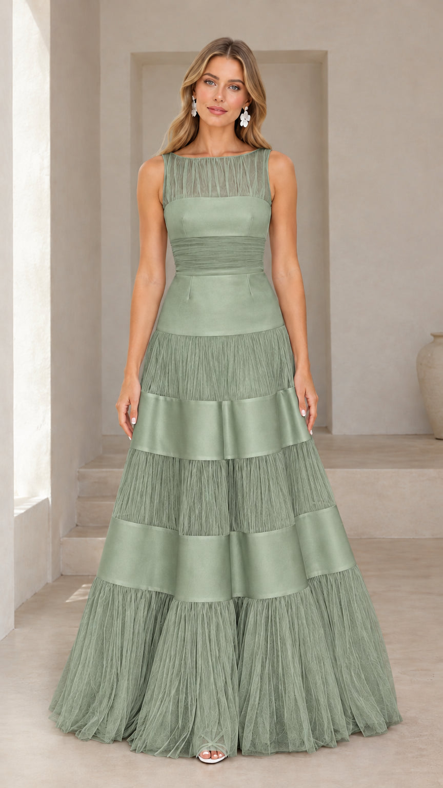 Front view of model wearing sage green tiered tulle and satin evening gown