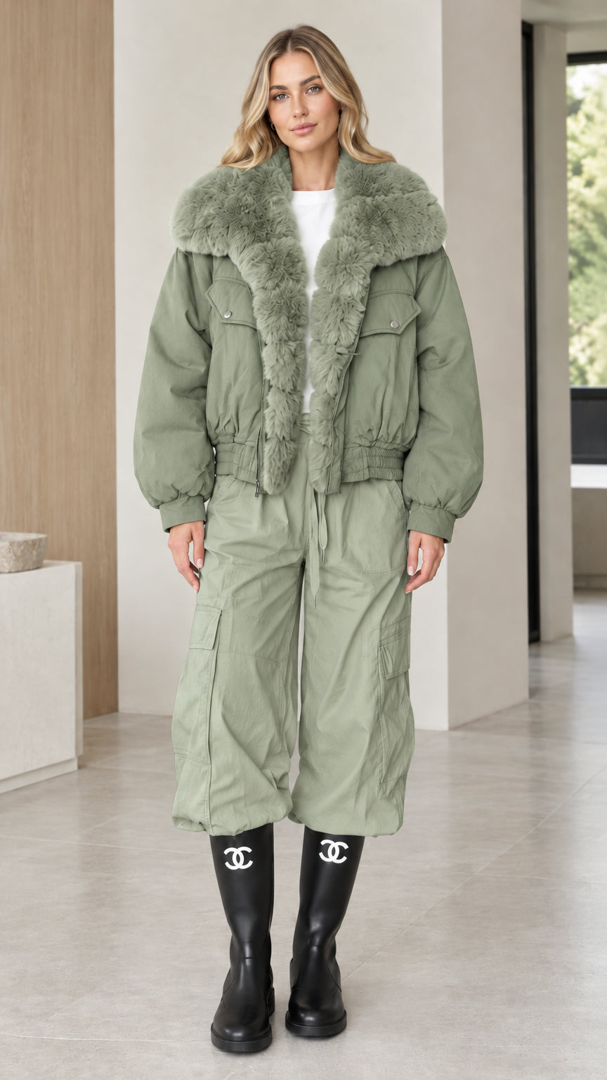 Model wearing sage green faux fur collar bomber jacket with cargo trousers