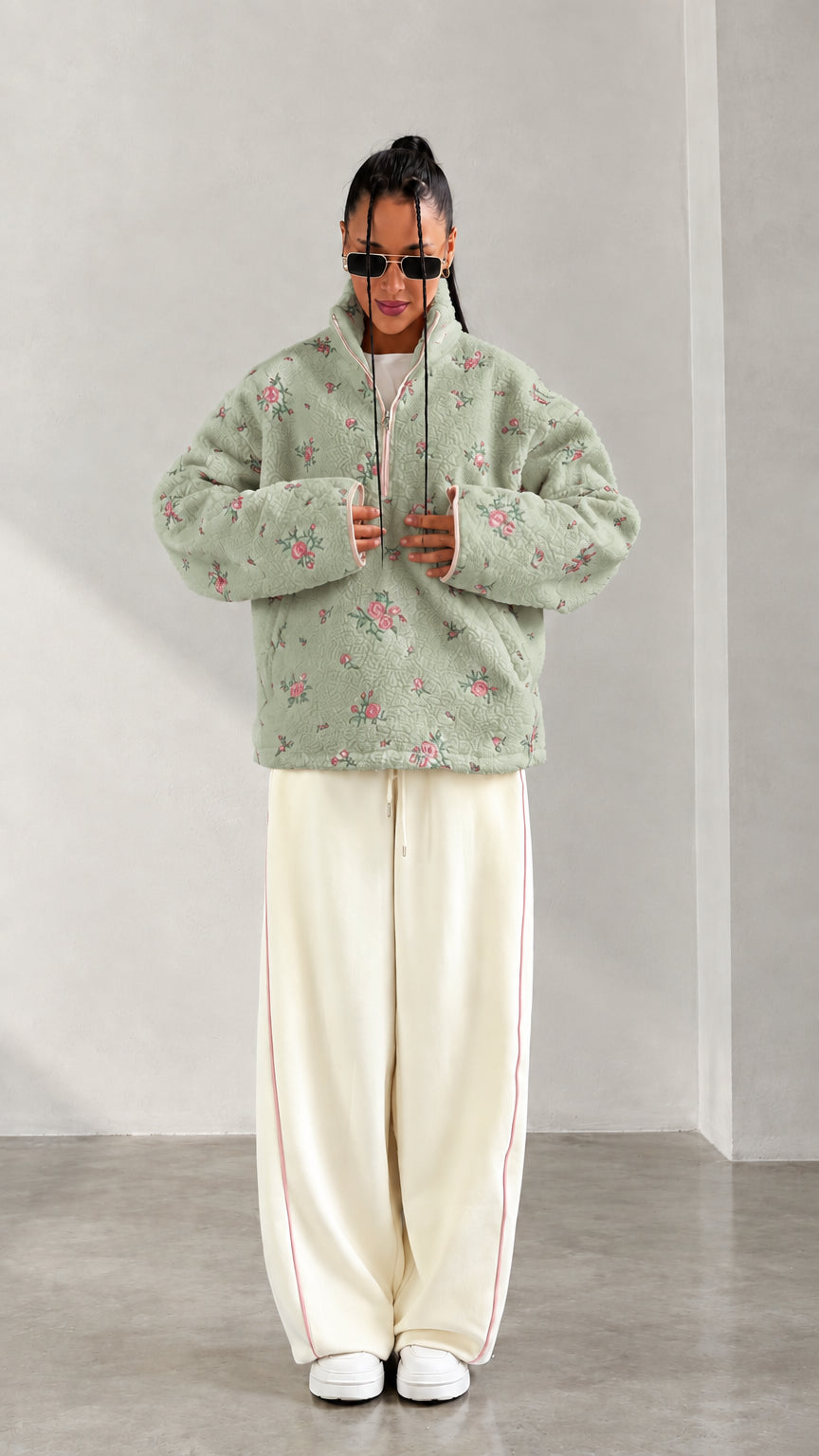 Front view of model wearing sage green floral print half-zip fleece pullover