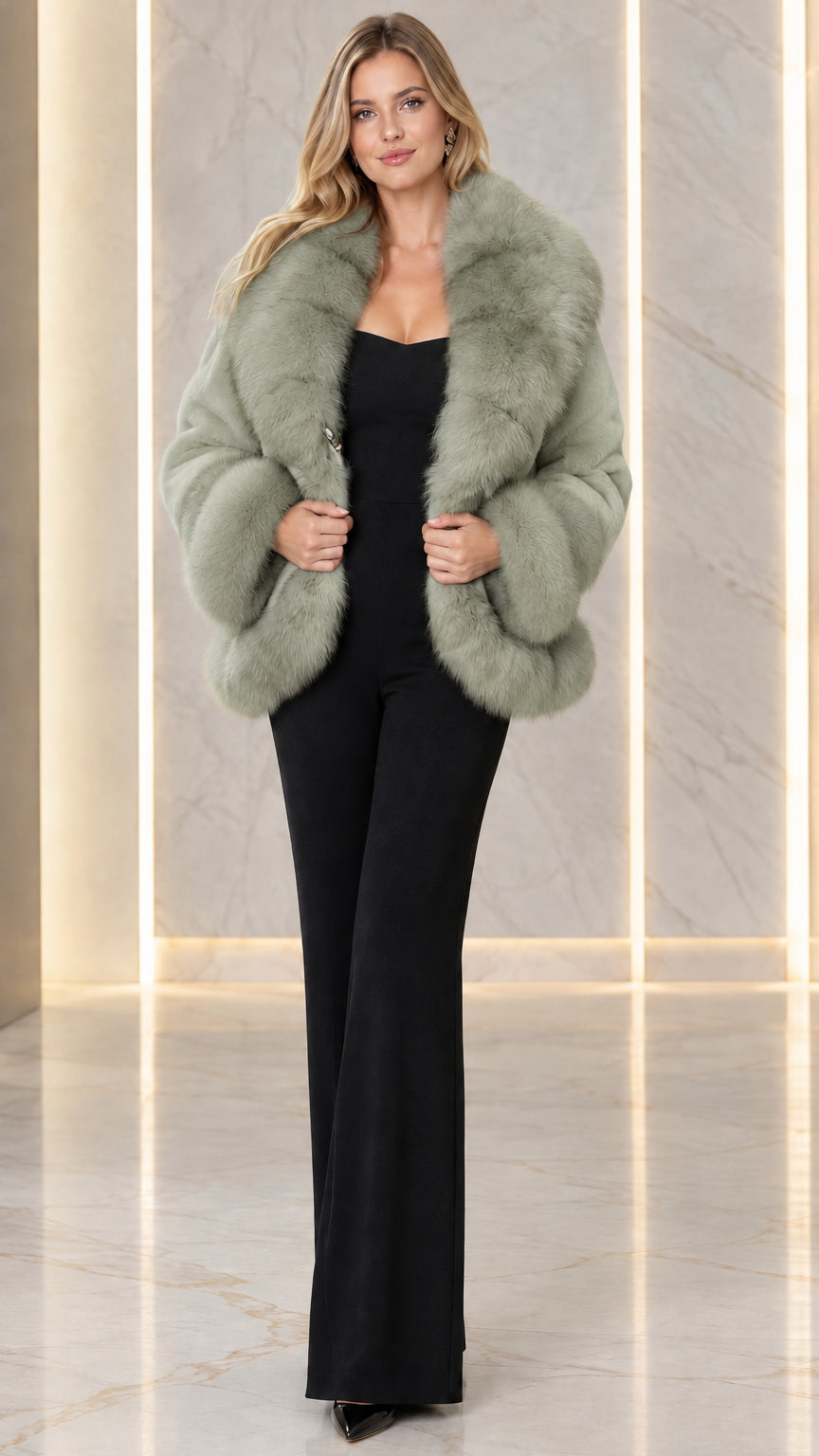 Model wearing sage green plush faux fur coat with contrast textured collar and cuffs